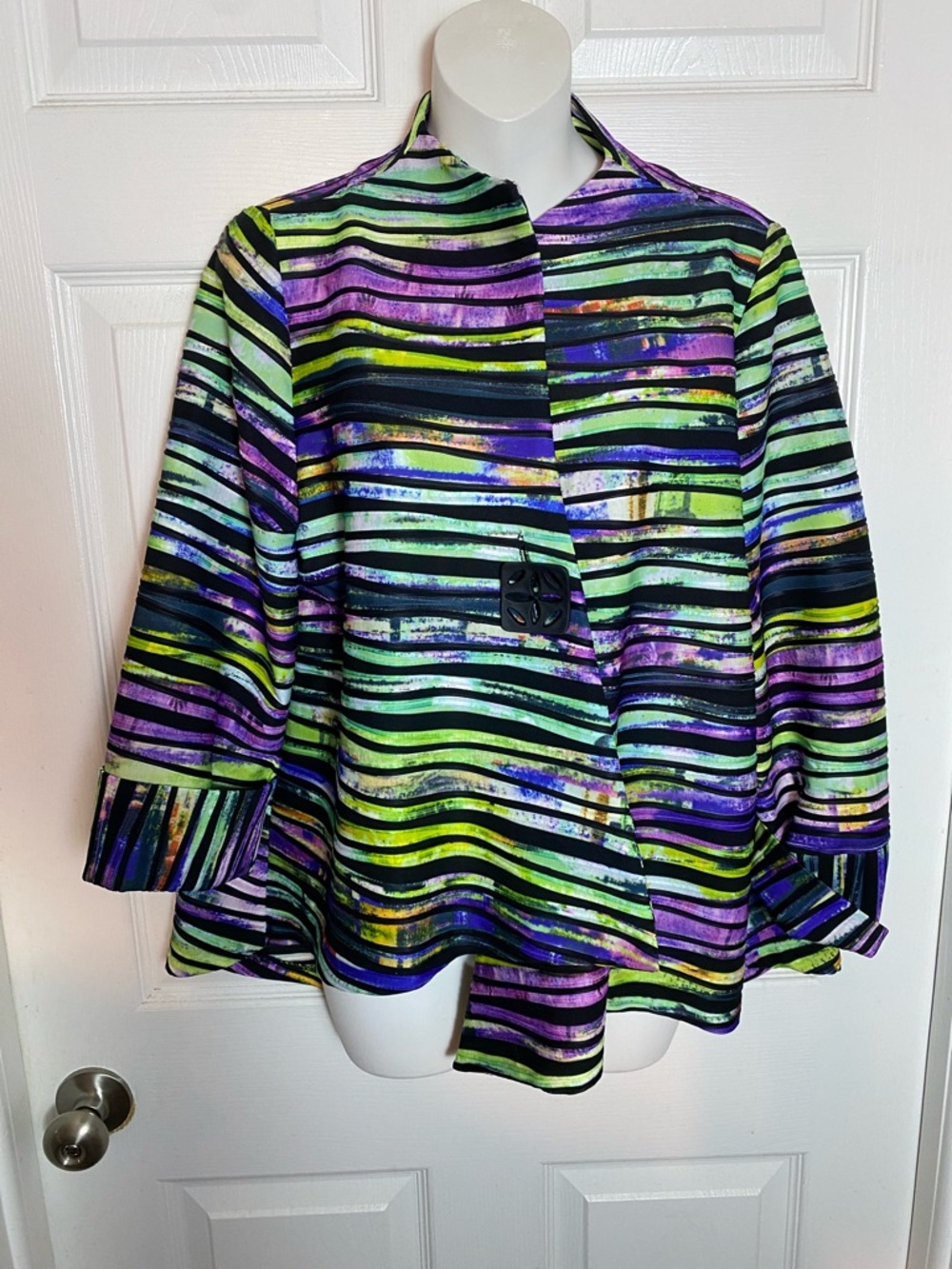 IC Connie K asymmetrical one-button swing jacket in a colorful striped pattern